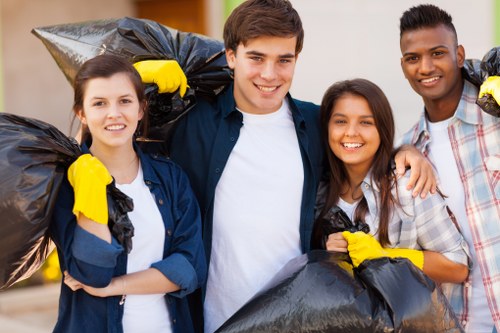 Workers loading segregated recyclables and reusable furniture for transfer